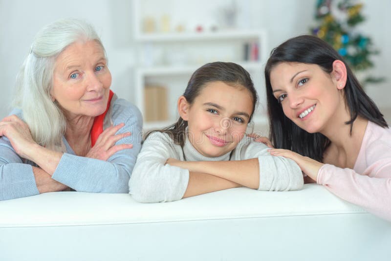 Three generations family resting on couch