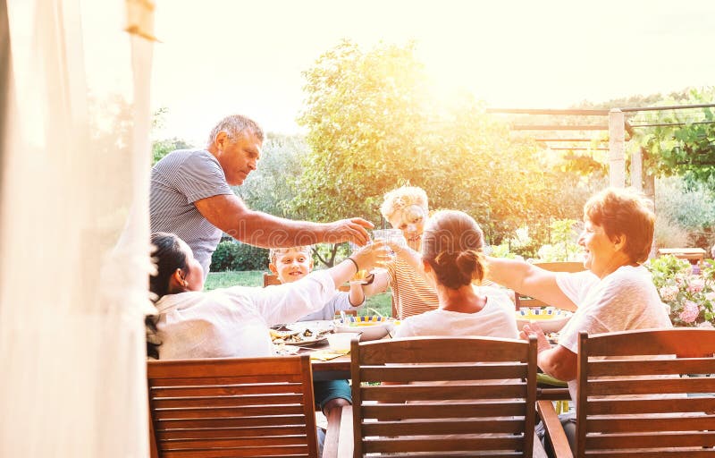 Big Family Have a Dinner with Fresh Cooked Meal on Open Garden T Stock