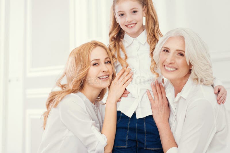Three generations of women posing for camera stock image Three generations of women posing for camera stock image
