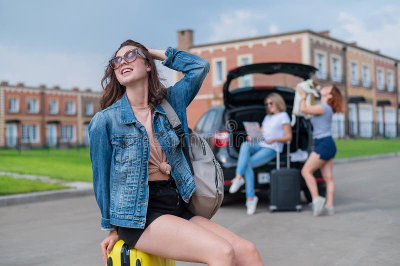 Three Girlfriends Go on a Road Trip. Young Woman Posing with a Suitcase ...