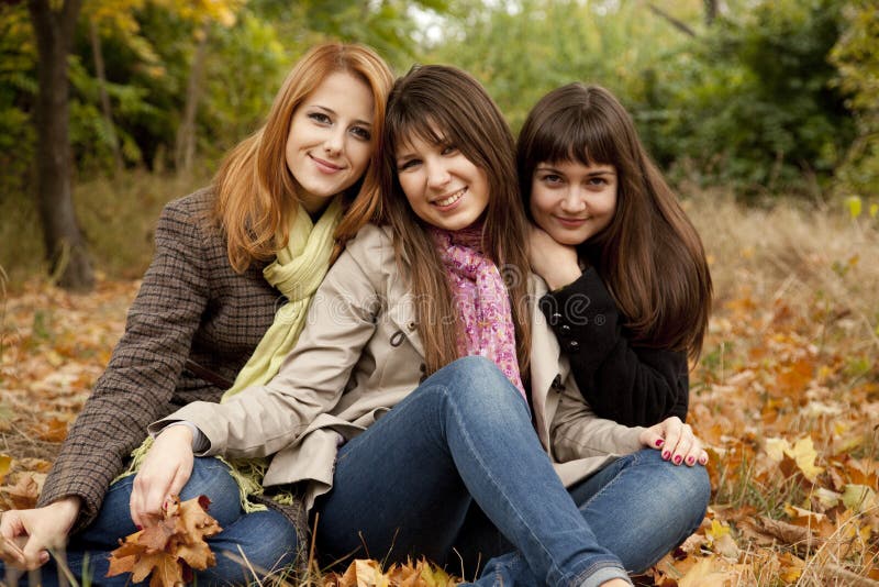 Three girls in the autumn park.