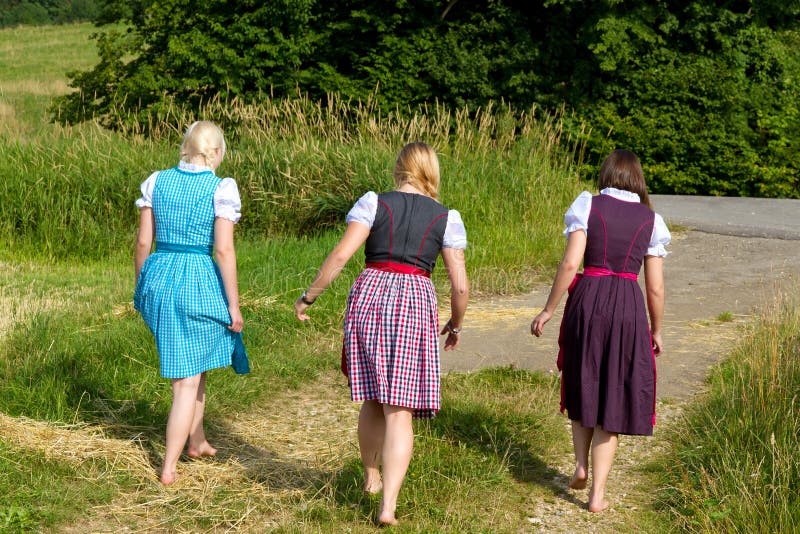 Three girls in dirndl stock photo. Image of barefoot - 26153946