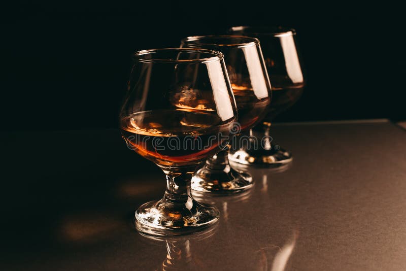 Three Glasses Of Cognac On A Black Background Stock Photo Image of