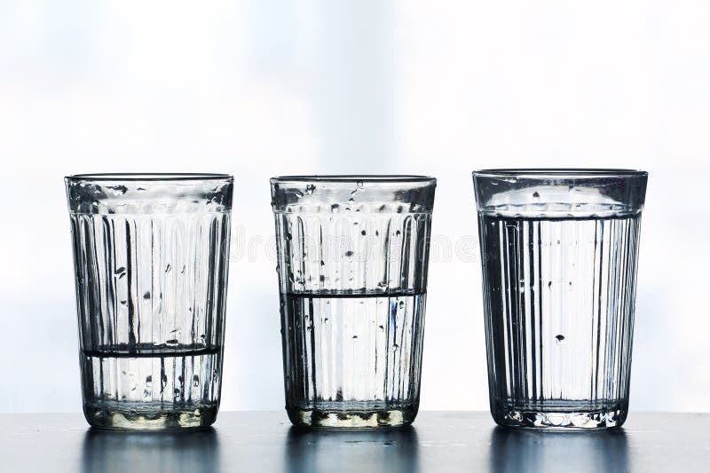 Three glasses with different levels of water stock image Three glasses with different levels of water stock image