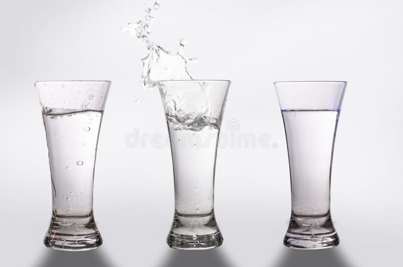 Three glasses and a splash of water stock photos Three glasses and a splash of water stock photos