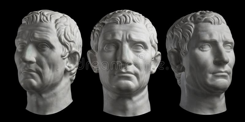 Three gypsum copy of ancient statue head of Guy Julius Caesar isolated on black background. Plaster sculpture man face. stock photography Three gypsum copy of ancient statue head of Guy Julius Caesar isolated on black background. Plaster sculpture man face. stock photography