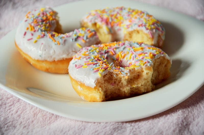 Three Halfeaten Donuts on the Plate Closeup Stock Photo Image of
