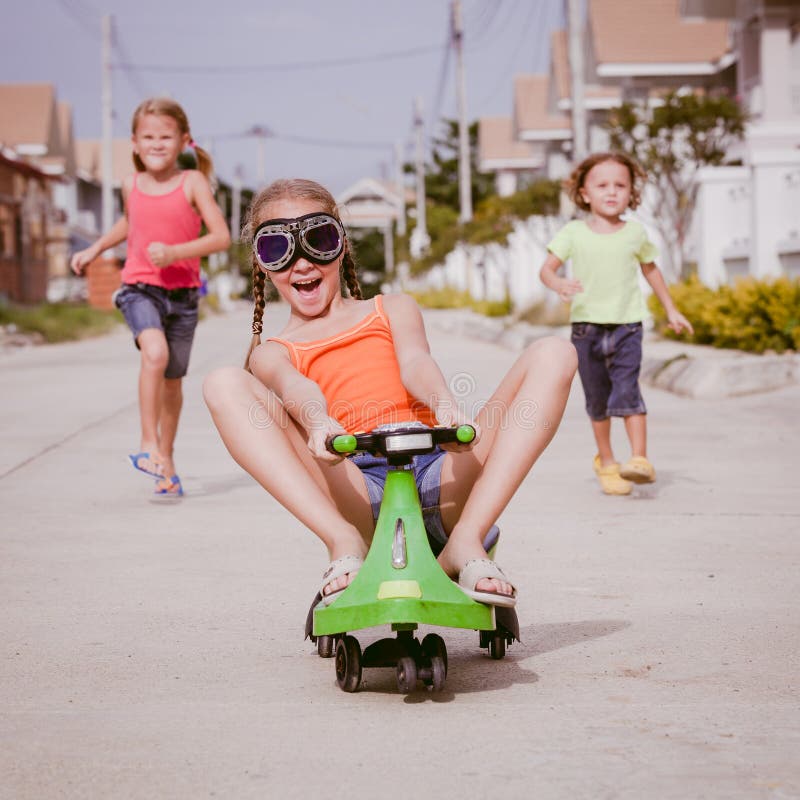 Three happy children playing on the road stock photography Three happy children playing on the road stock photography