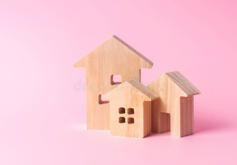 Three houses on a pink background. Buying and selling of real estate, construction. Apartments and residential buildings in a city. Or settlement. Investments stock photos Three houses on a pink background. Buying and selling of real estate, construction. Apartments and residential buildings in a city. Or settlement. Investments stock photos