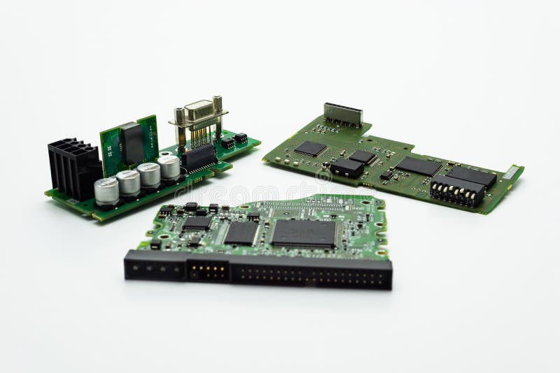 Three integrated circuits with visible microprocessors, capacitors and connectors stock photo Three integrated circuits with visible microprocessors, capacitors and connectors stock photo