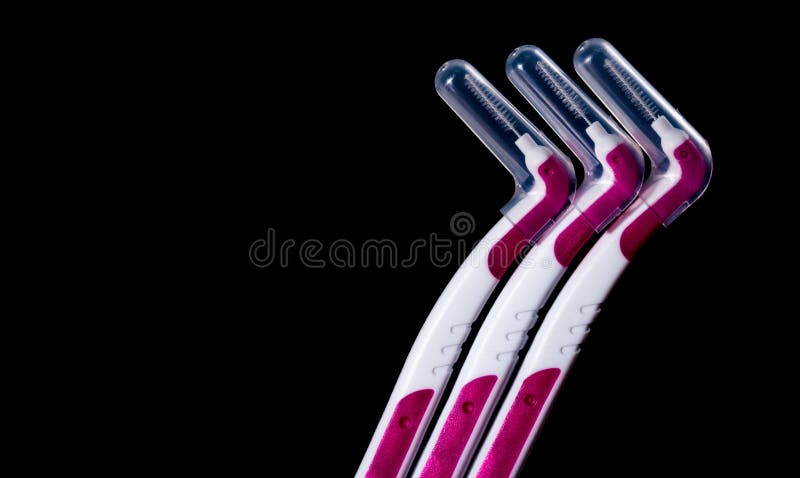 Three interdental brush with cover isolated on black background stock image Three interdental brush with cover isolated on black background stock image