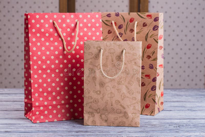 Three Kraft Paper Gift Bags with Printing. Stock Photo Image of
