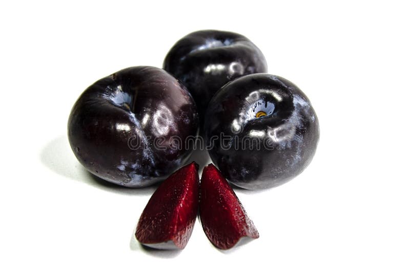 Three Large Red Plums and Two Juicy Slices of Plum Stock Image Image