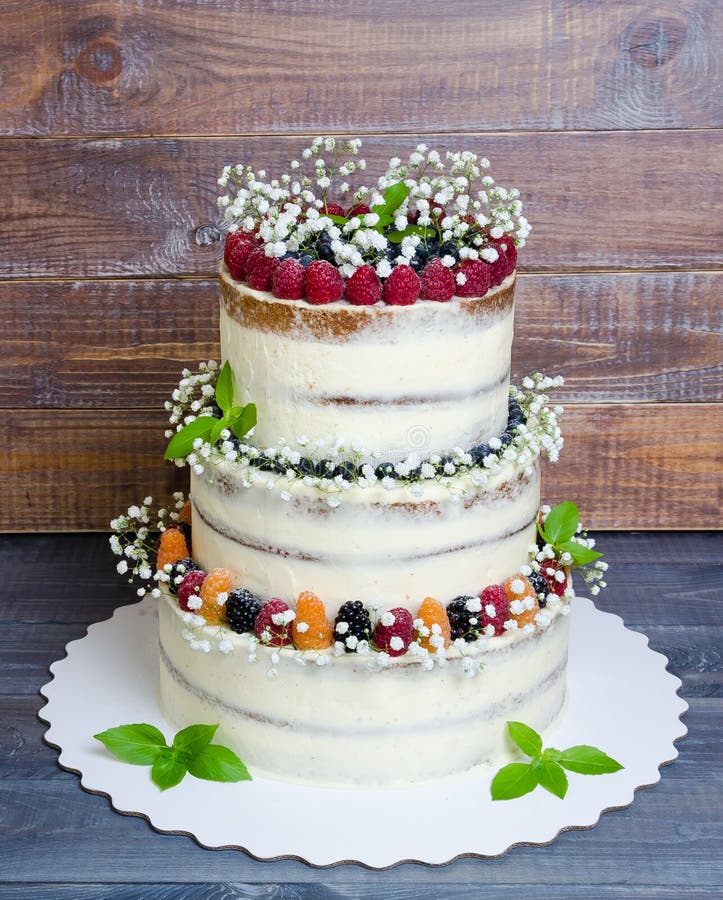 Three Layered Wedding Cake with Berries and Basil Leaves Stock Photo ...