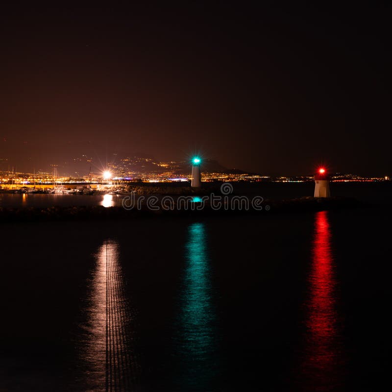 Three Lighthouses with Colorful Lights in the Bay Overlooking the City