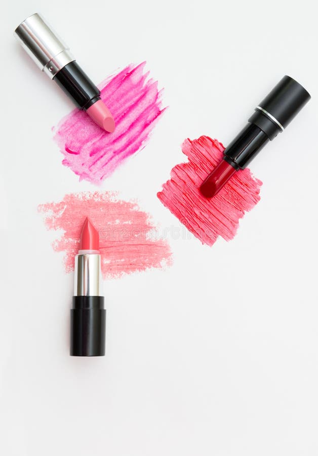 Three lipsticks of different color with swatches. View from above stock image Three lipsticks of different color with swatches. View from above stock image