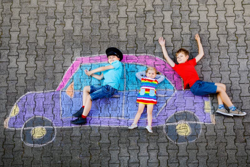 Three little children, two school kids boys and toddler girl having fun with with car picture drawing with colorful royalty free stock photography Three little children, two school kids boys and toddler girl having fun with with car picture drawing with colorful royalty free stock photography