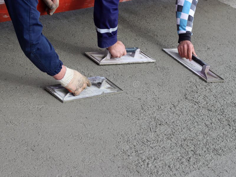 Three mason completed concrete surface stock image