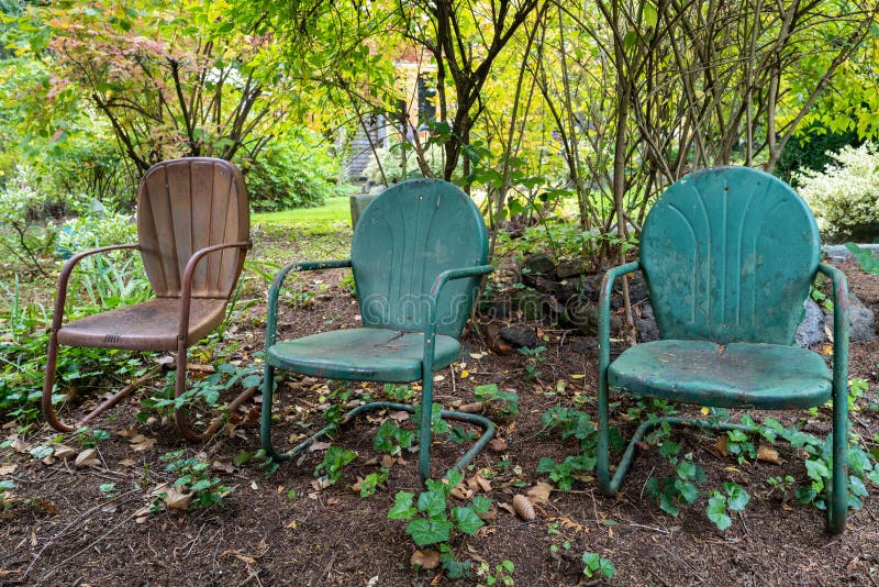 Three Metal Chairs in the Garden Stock Image Image of foliage