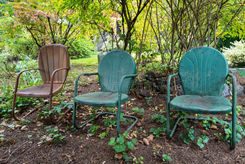 Three metal chairs in the garden