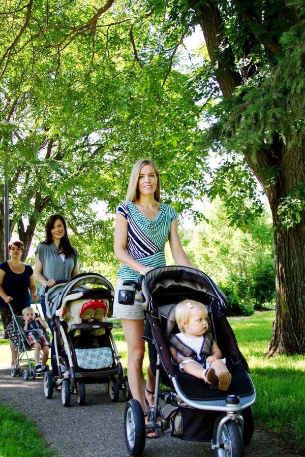 Three Mom s walking in park with children
