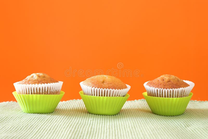 Three muffins in green cups