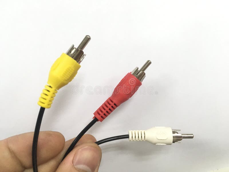 Three multicolored wires in a male hand on a white background stock images