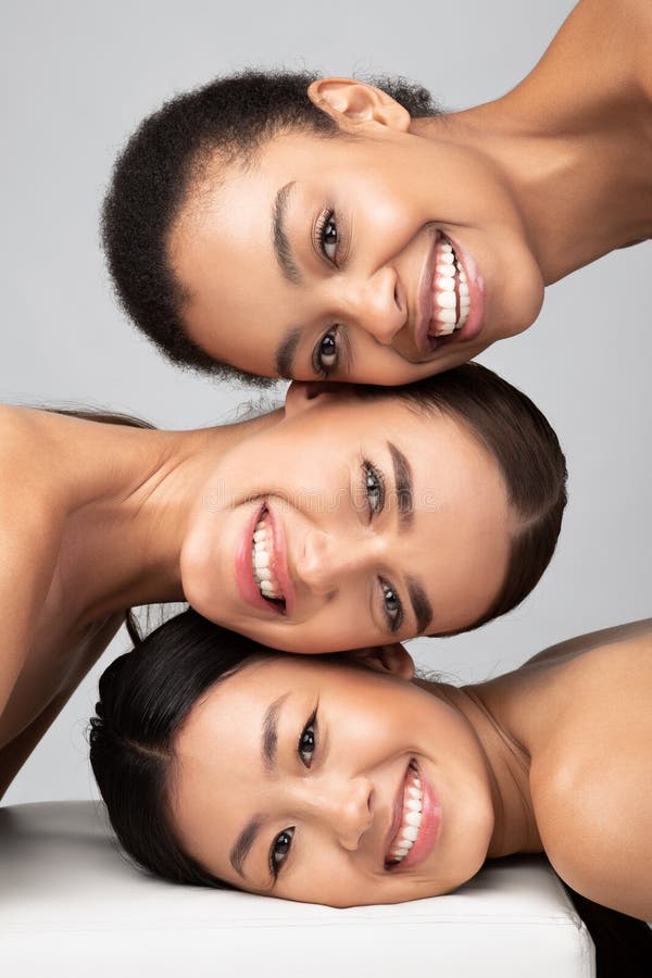 Three Multicultural Ladies Posing Over Gray Background, Beauty Portrait, Vertical royalty free stock photos