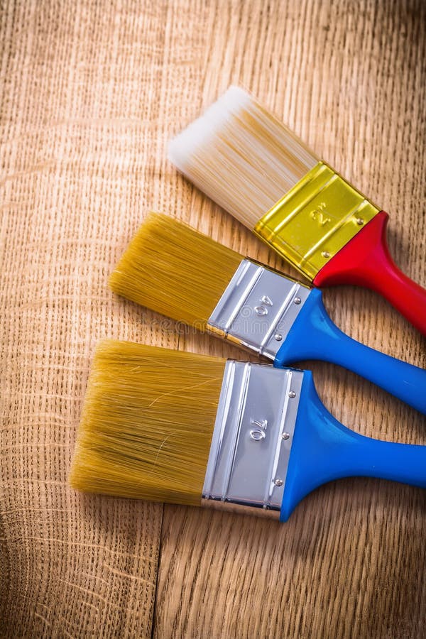 Three Paint Brushes on Wooden Board Construction Stock Photo Image of