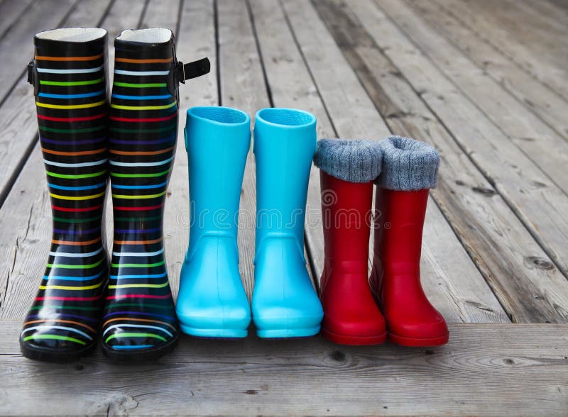 Three pairs of a colorful rain boots. Family concept