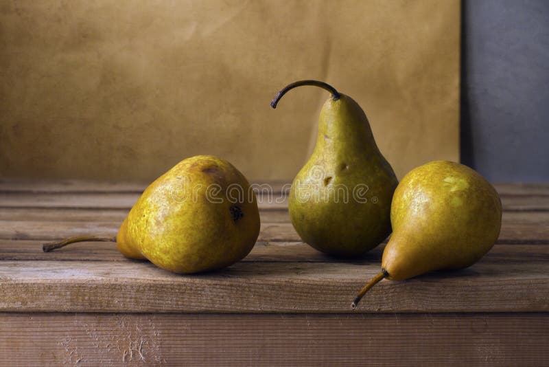 Three pears on wooden table