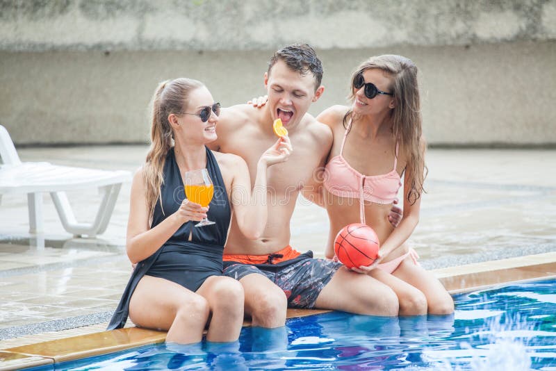 Three pelple in group of friends making party in the pool and Dr stock photography Three pelple in group of friends making party in the pool and Dr stock photography