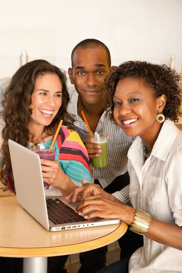 Three People Dining Out Using a Laptop royalty free stock photos