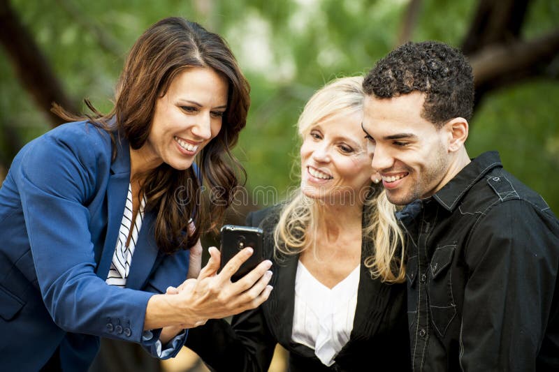 Three People looking at a Phone royalty free stock photos