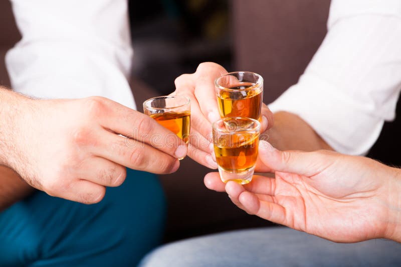 Three people with rum shots stock photography Three people with rum shots stock photography