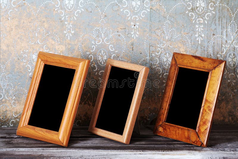 Three photo-frames on old table