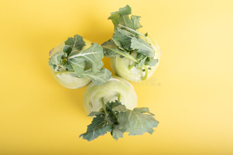 Three Pieces of Kohlrabi Vegetable Isolated on Yellow Simple Background