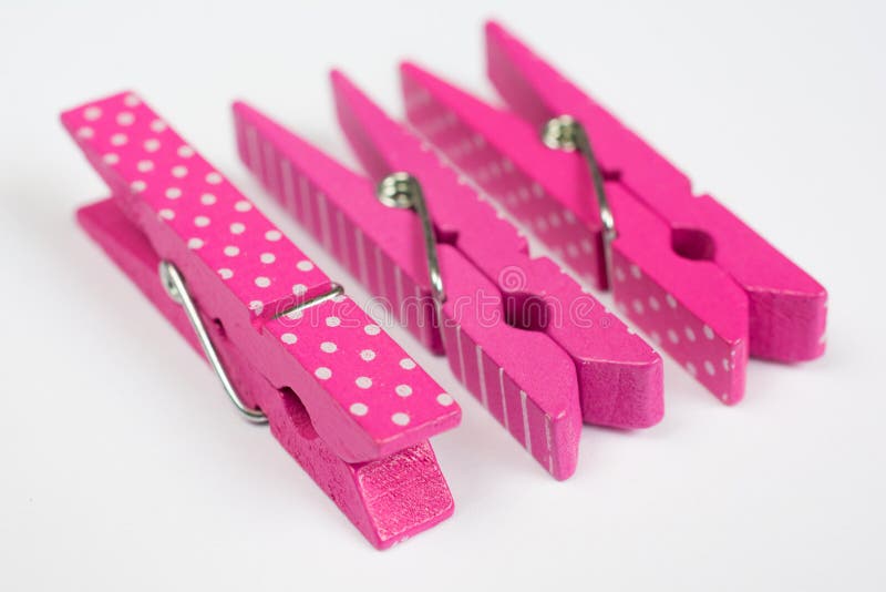 Three Pink Clothes Pins with Fun Patterns Two on Sides Perspective View