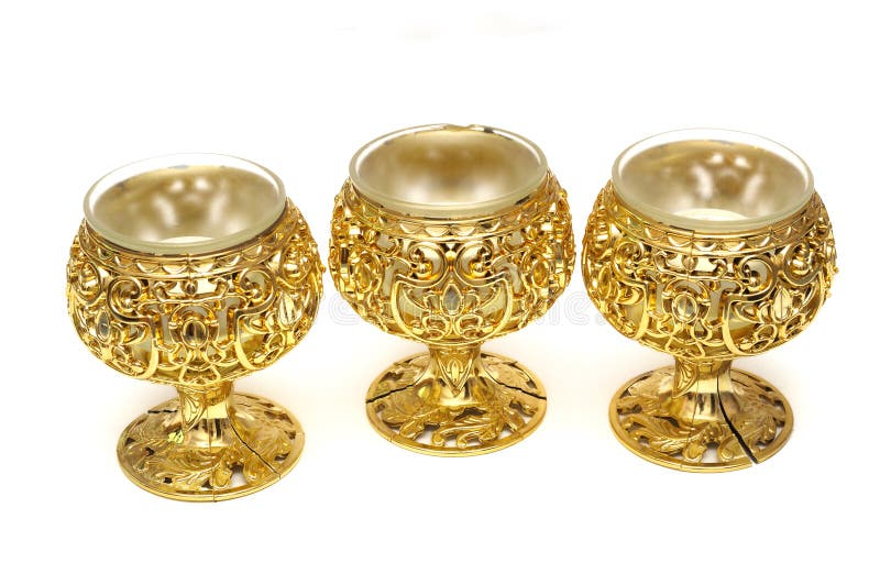 Three Plastic Golden Colored Table Cup Candle Holders Stock Image
