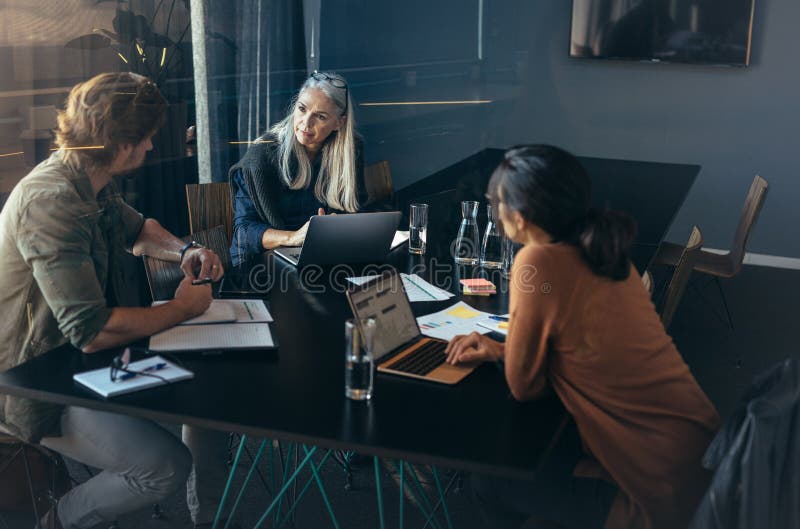 Businesspeople having a meeting in office stock photo Businesspeople having a meeting in office stock photo