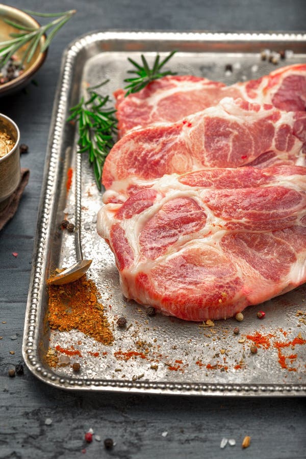 Three Raw Pork Steaks on Iron Tray on Dark Surface Stock Image Image