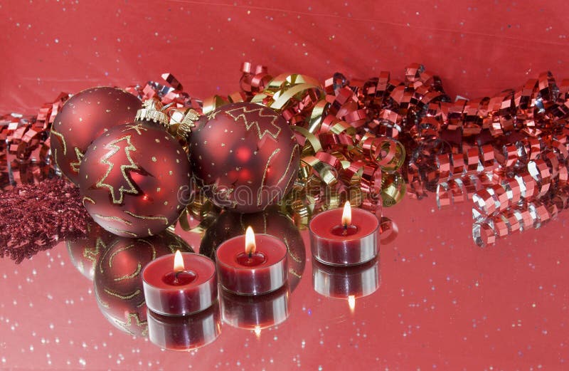 Three red baubles with tealights
