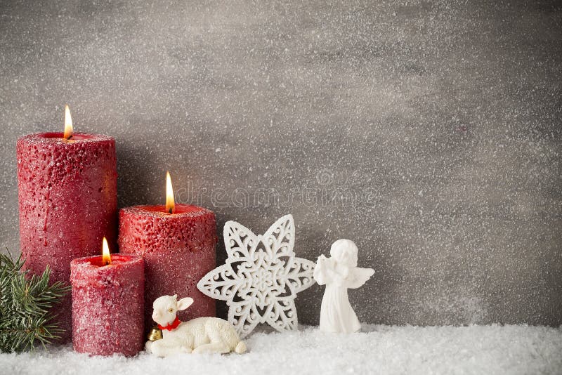 Three red candles on gray background, Christmas decoration. Advent mood.