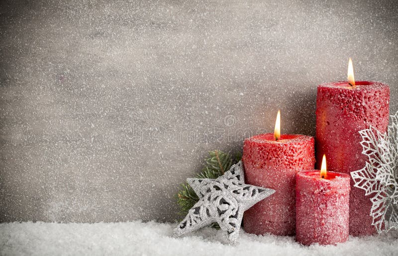 Three red candles on gray background, Christmas decoration. Advent mood.