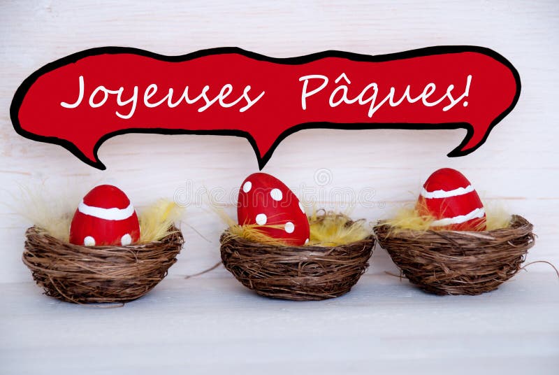 Three Red Easter Eggs With Comic Speech Balloon French Joyeuses Paques Means Happy Easter royalty free stock images