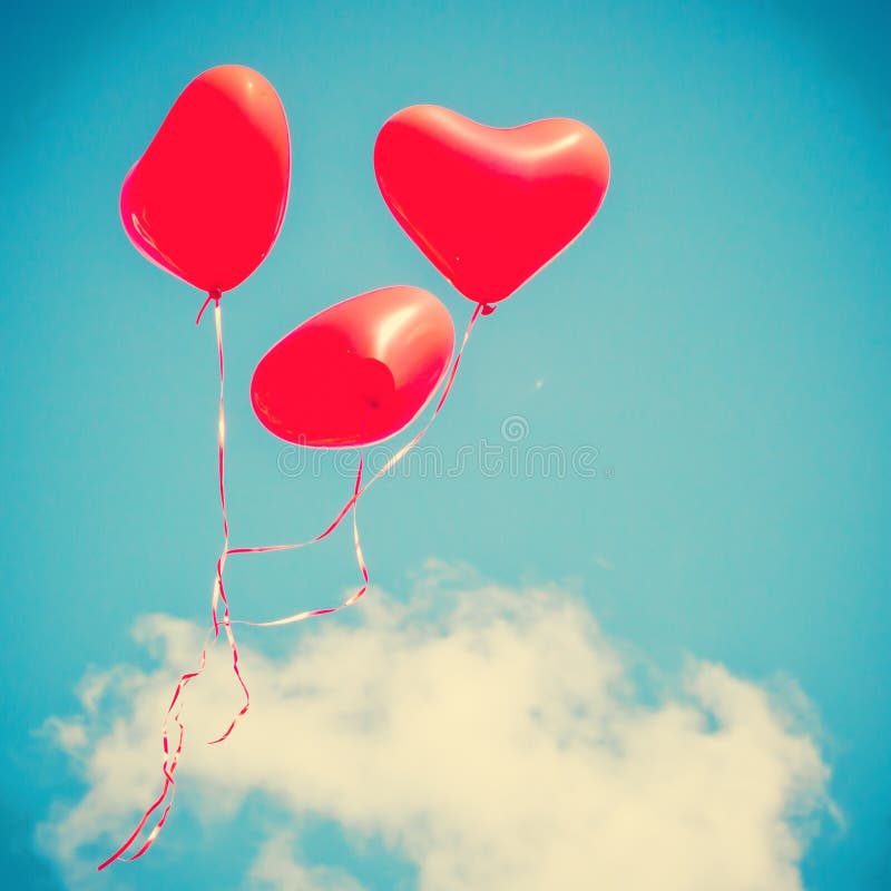 Three Red Heart-shaped balloons