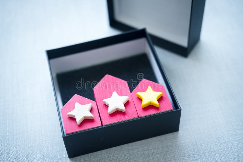Three red houses in box with rating star. Symbol of successful choice royalty free stock photography