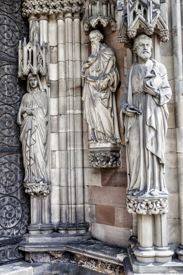 Three Religious Statues on a Church Wall Stock Image Image of england