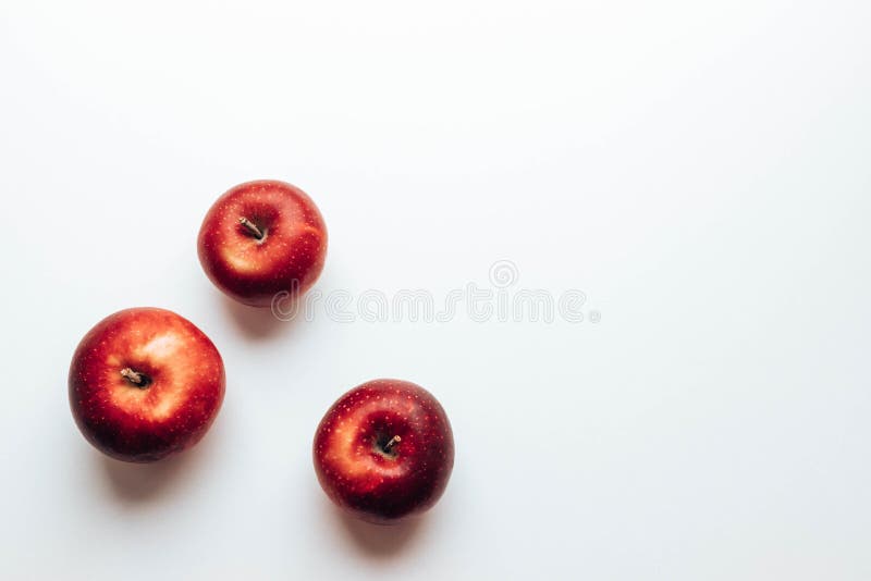 Three ripe juicy red rayal gala apples on grey backgroung. Top view. Autumn composition. Flat lay, top view, copy space. Three ripe juicy red rayal gala apples on grey backgroung. Top view. Autumn composition. Flat lay, top view, copy space