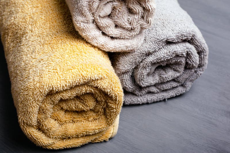 https://thumbs.dreamstime.com/b/three-rolled-folded-towels-pastel-colors-gray-background-close-up-three-rolled-folded-towels-pastel-colors-gray-182033948.jpg